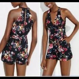 Express sleeveless romper, black floral, size 6.  It has pockets!